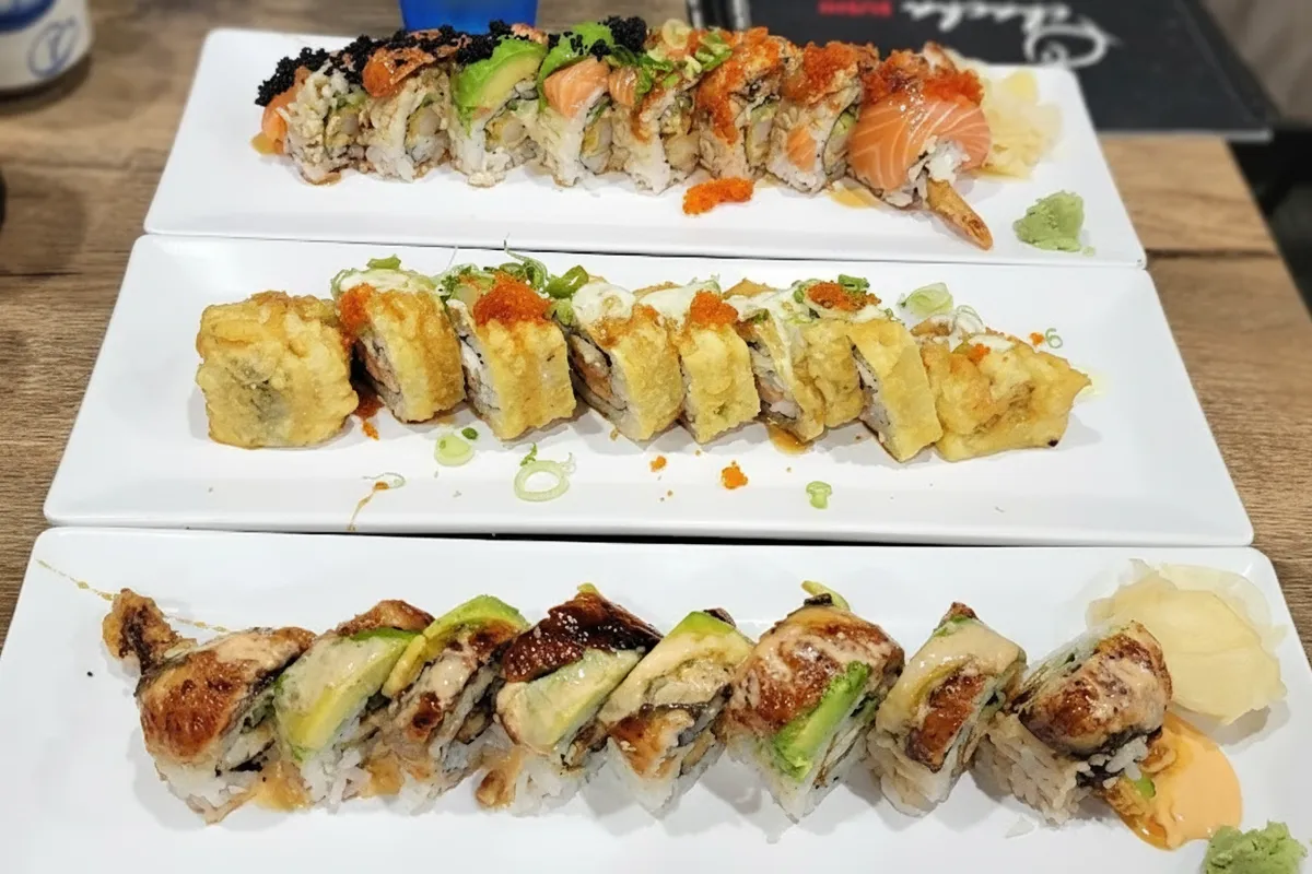 Colorful specialty rolls with bright roe topping